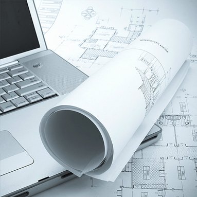 Bauzeichnungen und ein Laptop